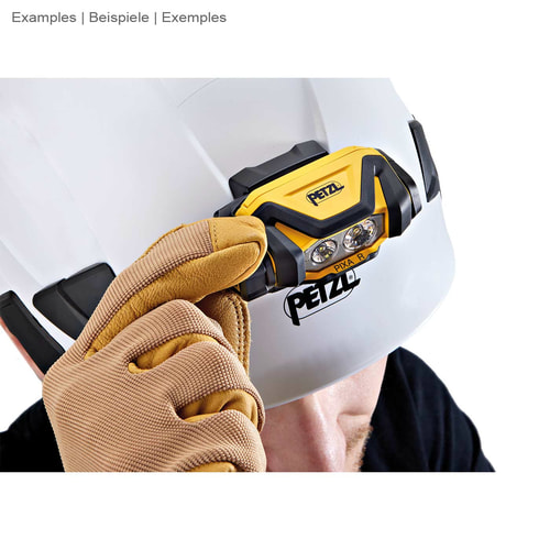 Petzl Pixa R headlamp mounted on a white safety helmet, one hand with a work glove touches the lamp