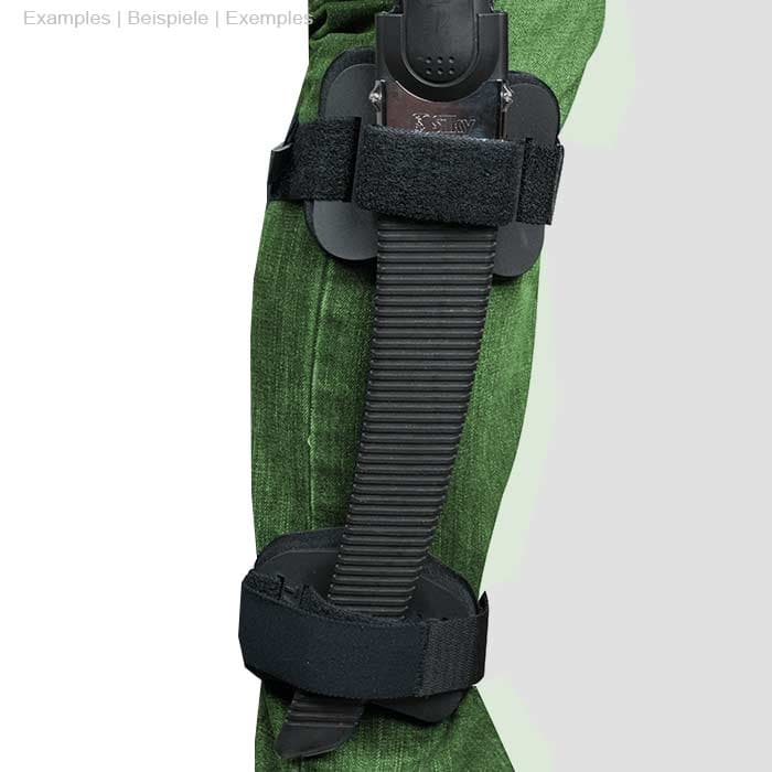 Person wears green pants, the Talon Mount is attached to the leg with a black handsaw