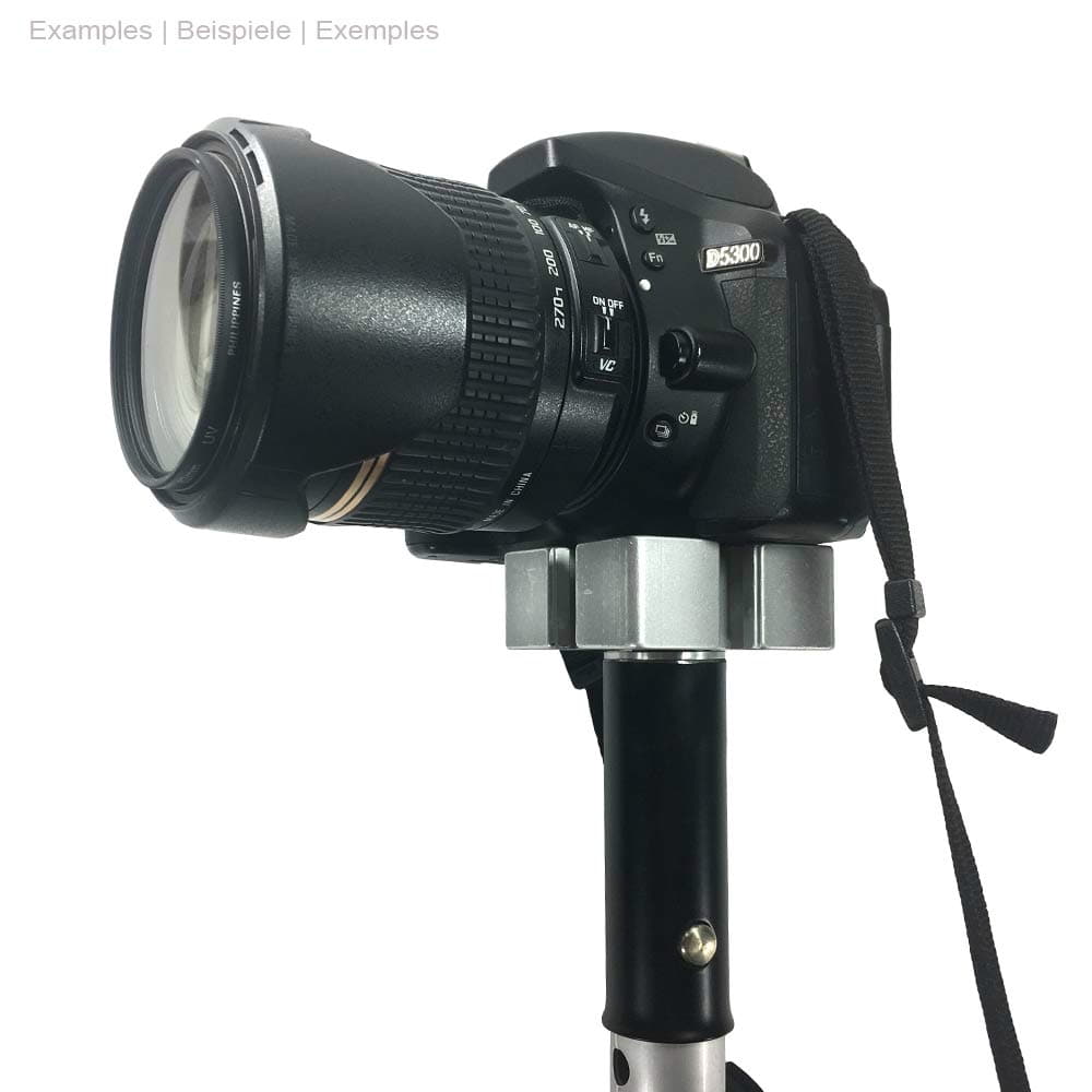 Digital camera with lens, mounted on a tripod with ArboRapid MediaAdapter Rigid in black and silver, camera has a black carrying strap