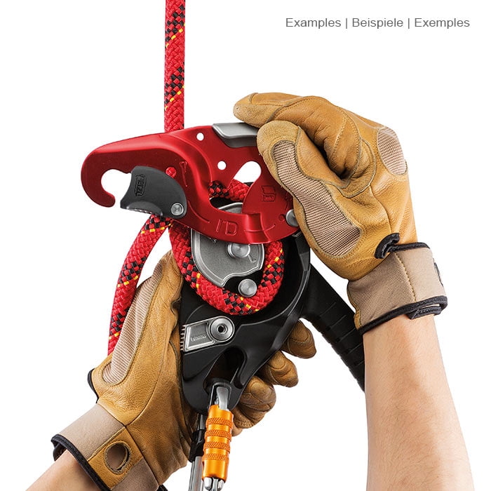 I'D L by Petzl, the climbing frame is held by two hands with brown gloves, a red rope is threaded