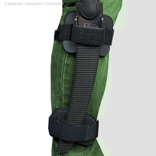 Person wears green pants, the Talon Mount is attached to the leg with a black handsaw