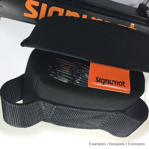 Black padded compartment with orange signumat label and visible metal pins