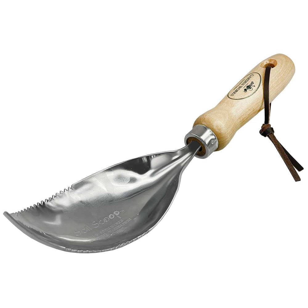 Soil Scoop with wooden handle and metal blade, edge of the blade toothed, a leather strap on the handle