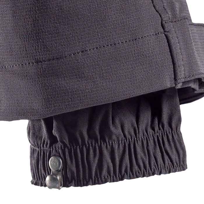 SIP climbing pants, close-up of the trouser leg hem with elastic waistband and two metal buttons for closure