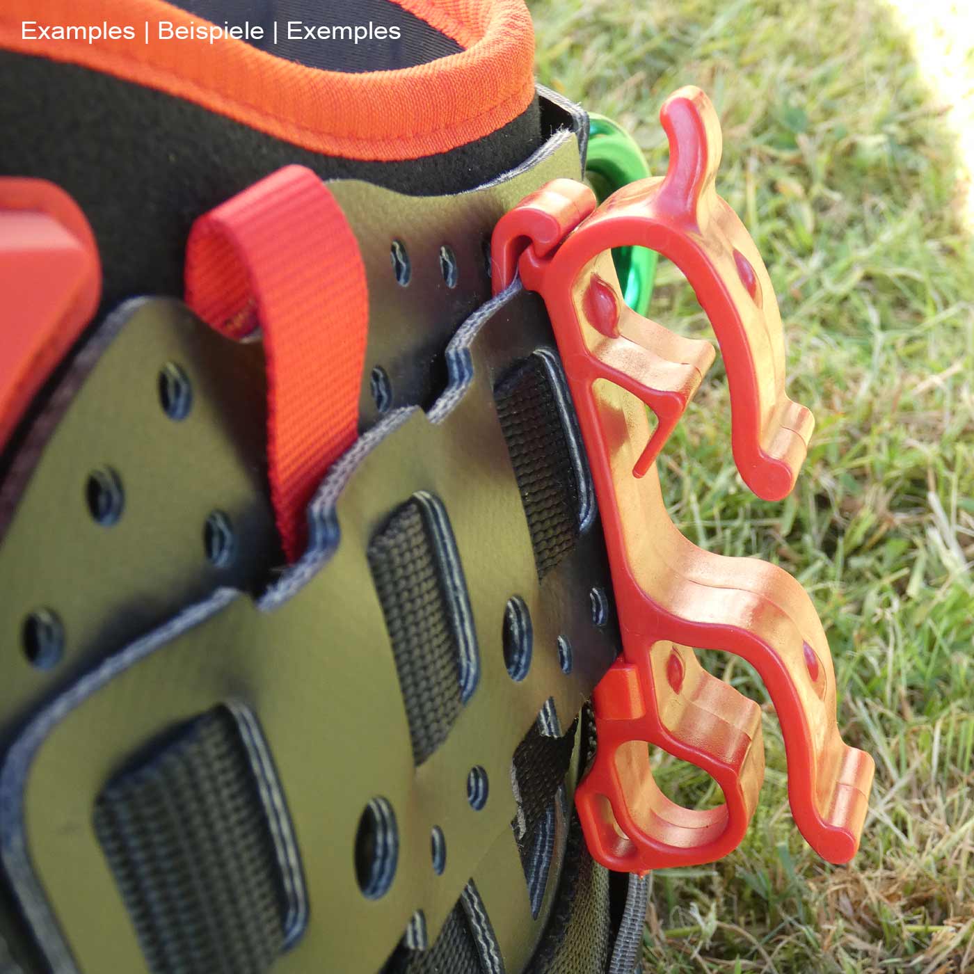 Buddy red plastic clip on black climbing harness with orange edge and red loops