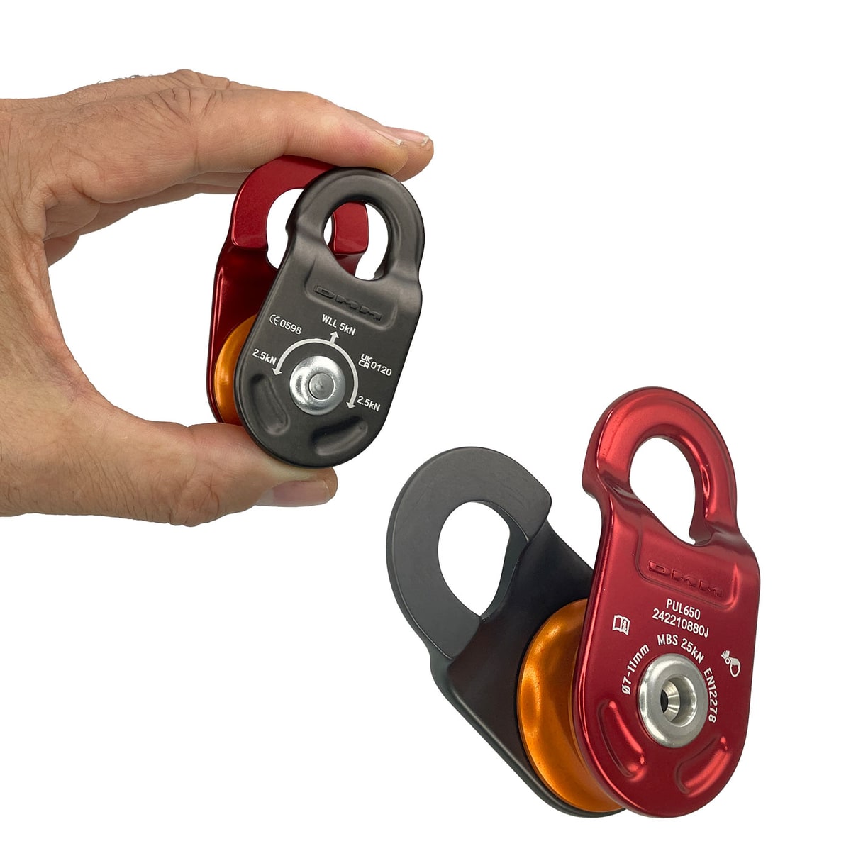 Hand holds an impeller with red and black housing and orange roller, next to it lies another pulley of the same type, manufacturer's name not visible