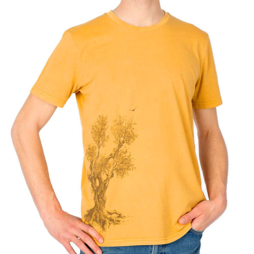 Olive Tree T-shirt, close-up of a yellow t-shirt with brown olive tree print, worn by a man with one hand in his pocket