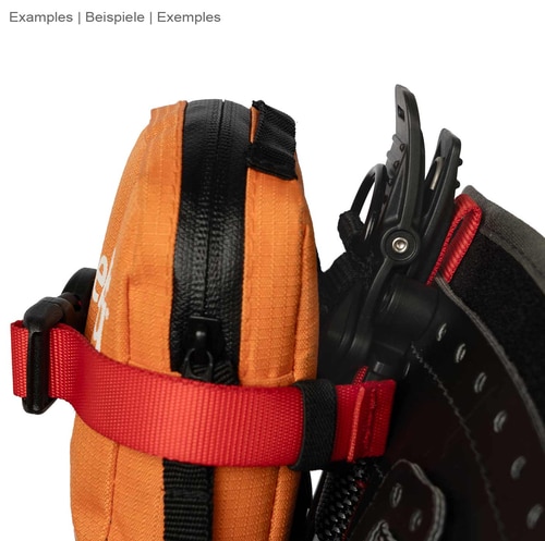 Caiman by DMM, red ribbon attached to an orange zippered bag with black Velcro closure