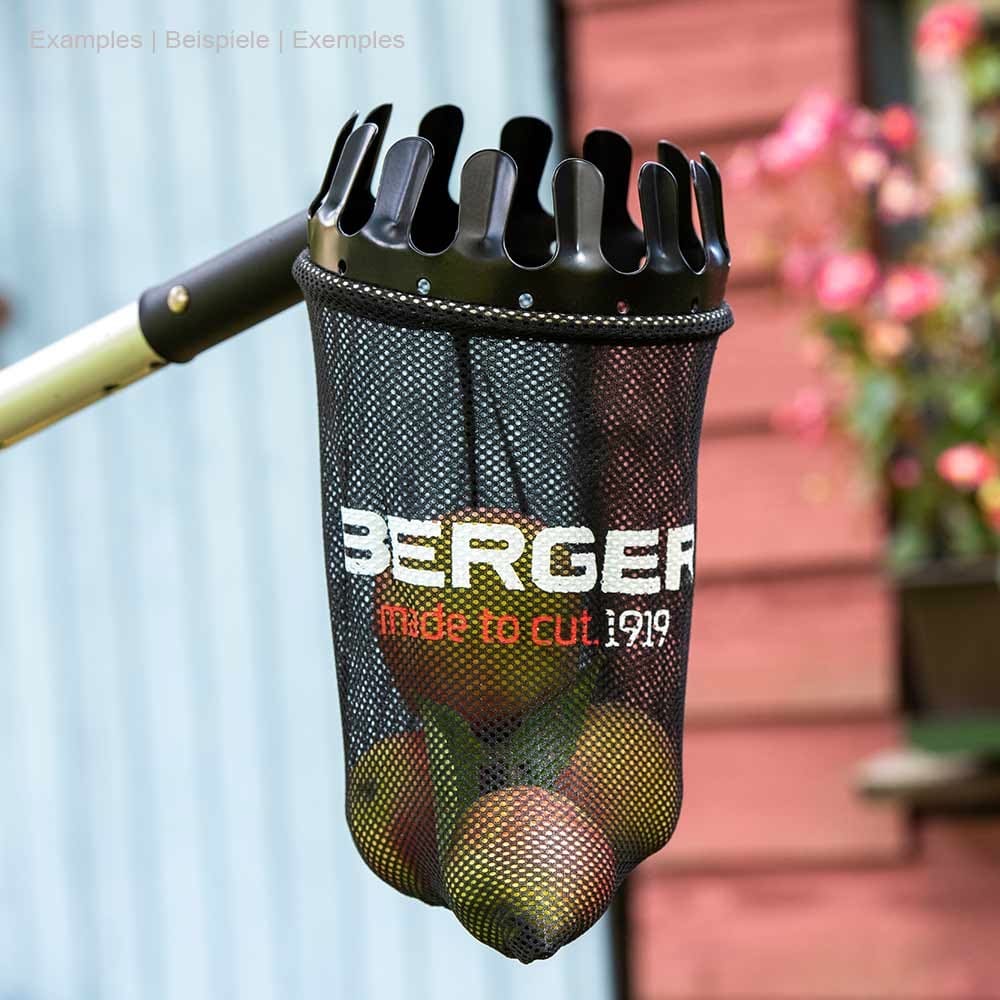 ArboRapid fruit picker with black mesh bag and metal crown, filled with several apples, against blurred background with red wooden walls and flowers