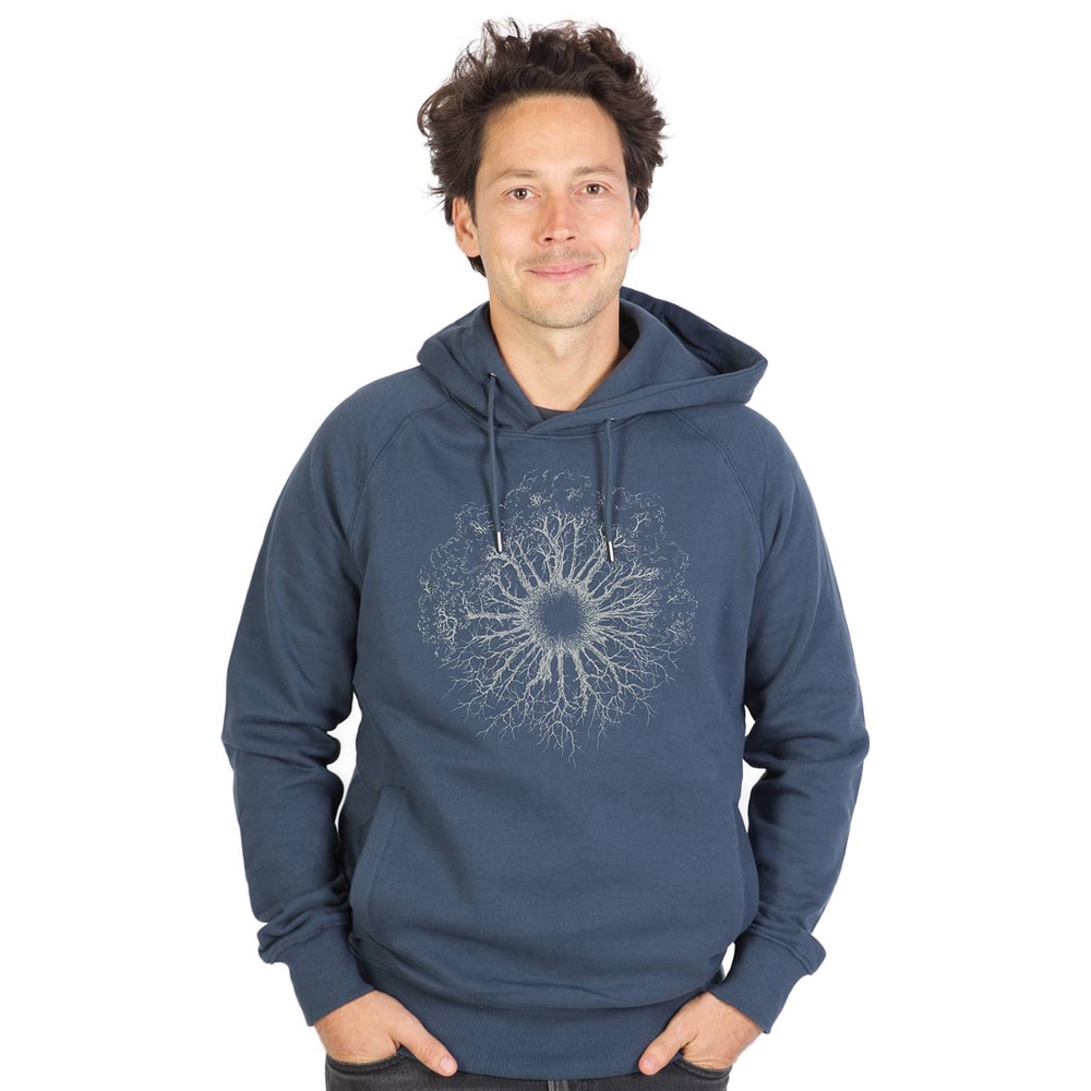 A man wears a blue Wooden Iris hoodie with a hood and a white, treeroot-like pattern on the chest.