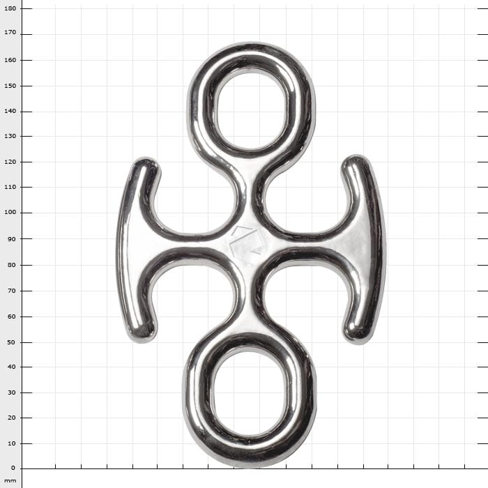 Backbone Mini, silver metal part with four openings, photographed on checkered background