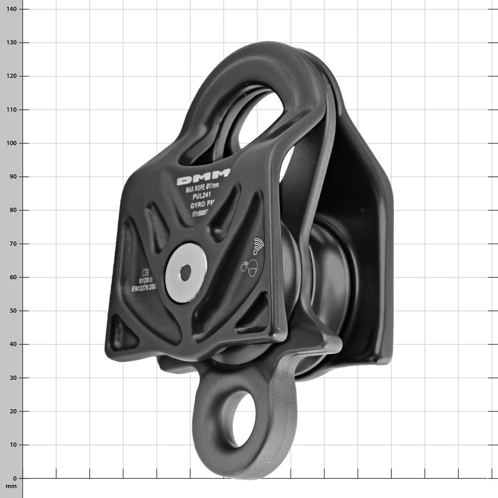 Black DMM Gyro Twin pulley with metal axle and hole for fastening, side view against checkered background