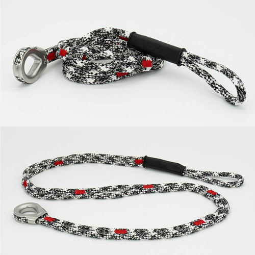 canopyANCHOR Thimble made of black, white and red rope with metal eyelet and loop, lying on a white background