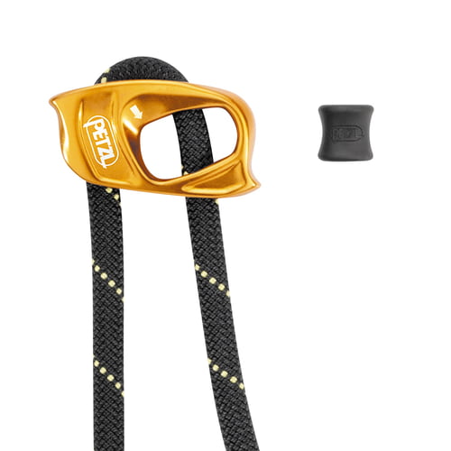 Close-up of the yellow metal device with Petzl logo and black rope with yellow dots, next to a small black rubber part with Petzl logo