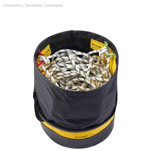 Round yellow and black Petzl Bucket 45 with open black cord closure at the top, filled with a white climbing rope with black dots