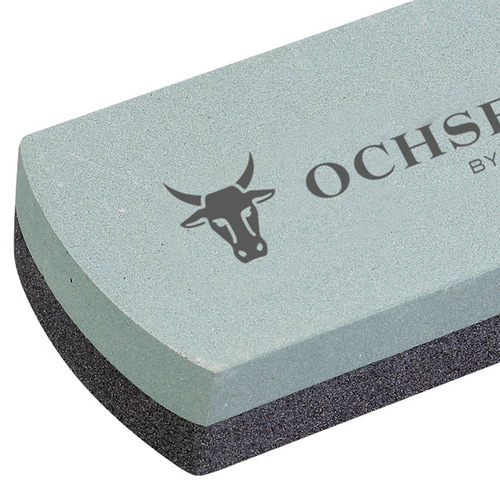 Close-up of the silicon carbide grindstone, focus on the light gray surface with the lettering "OCHSENKOPF BY GEDORE" and the bull's head logo