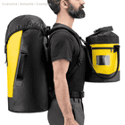 Man wearing Petzl Transport 45 backpack in yellow and black and holding a smaller yellow and black zippered pouch