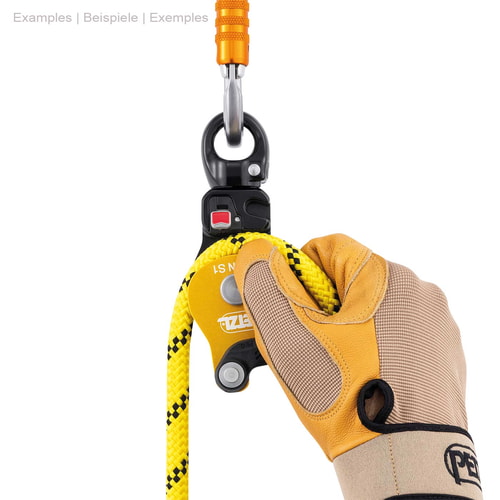 Petzl Spin S1, yellow and black pulley with metal ring on top, yellow rope and hand with work glove holding the rope