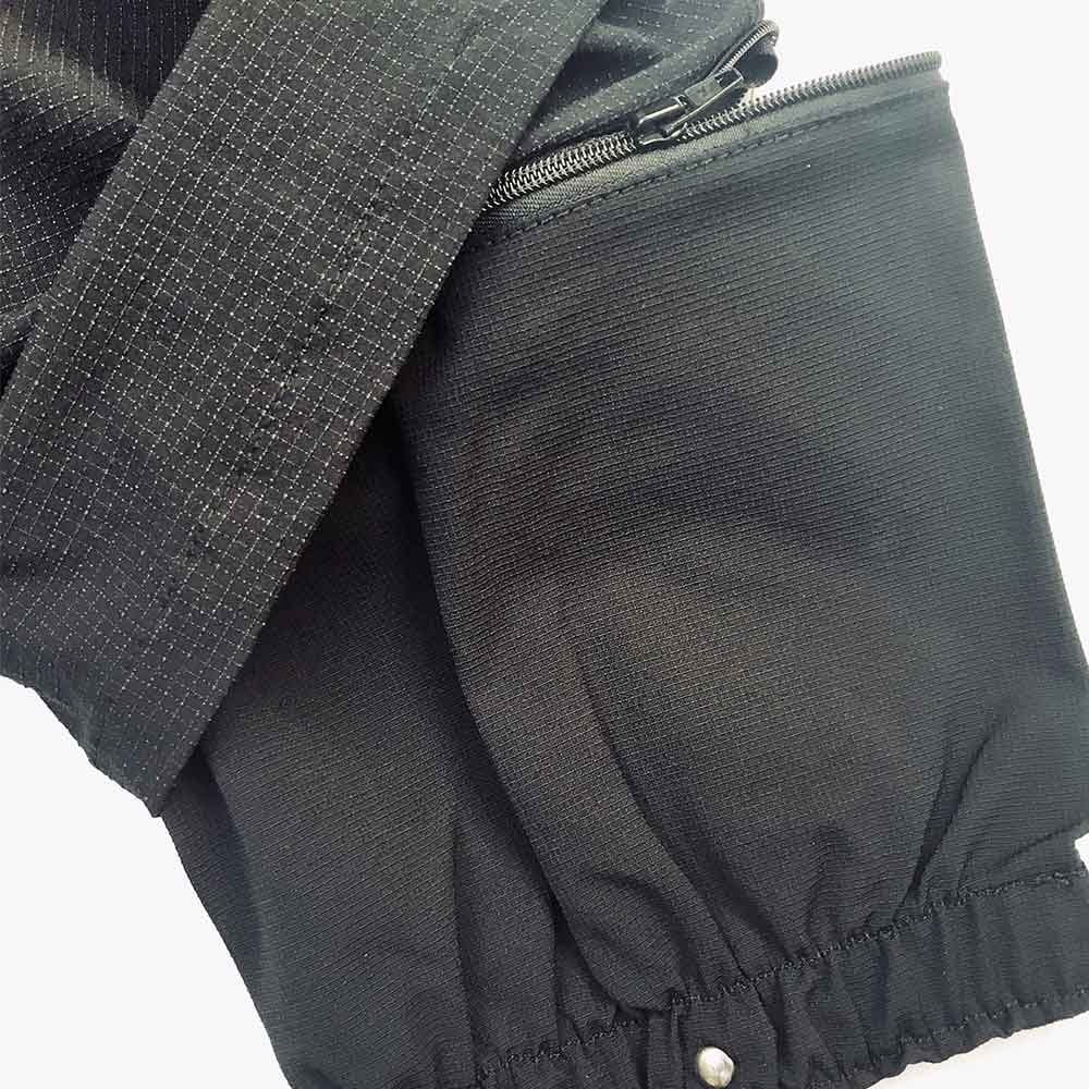 Close-up of Hermes trousers with zipper and elastic cuff in black