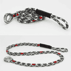 canopyANCHOR Thimble made of black, white and red rope with metal eyelet and loop, lying on a white background