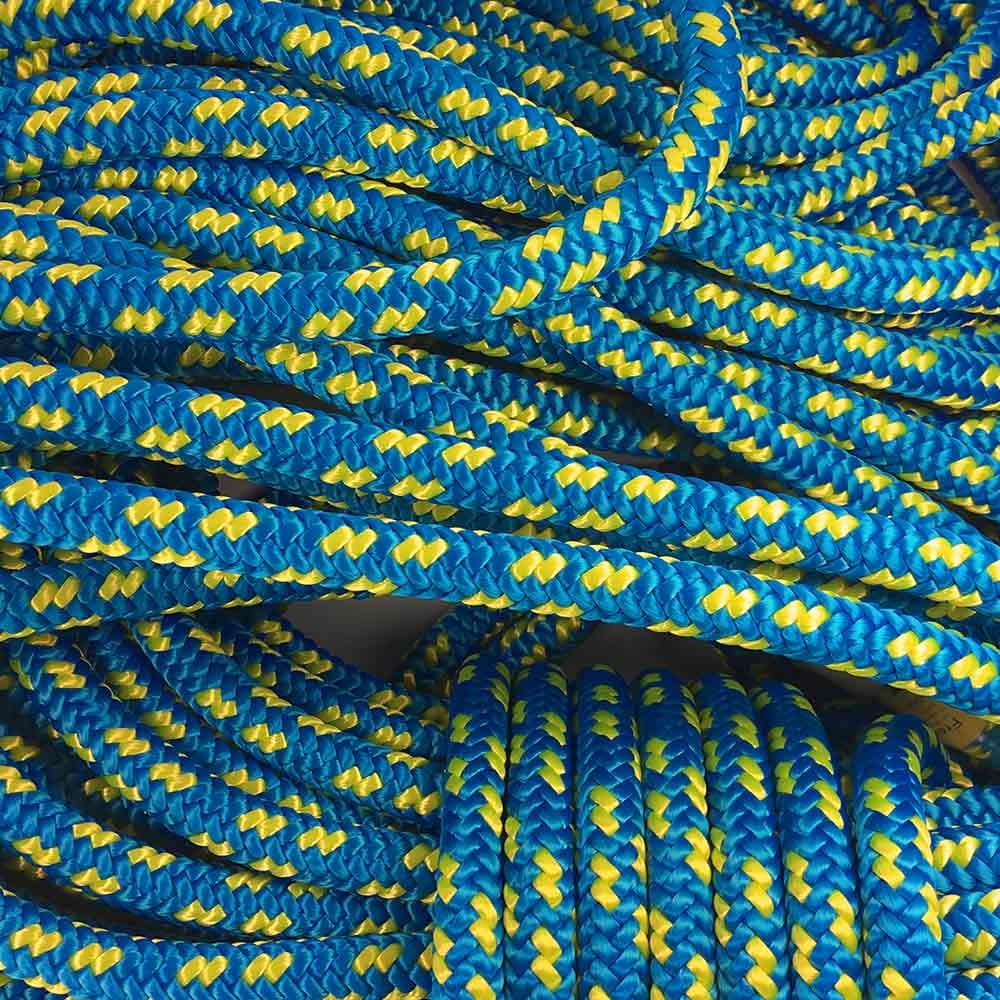 Several blue and yellow XP-e Aruba ropes lie loose and coiled on top of each other