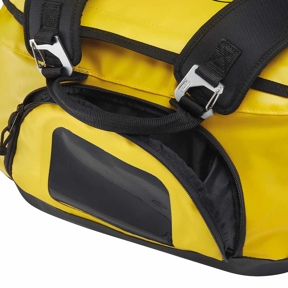 Detail of the black carrying straps and a side zipper compartment of the yellow PETZL Duffel 85 bag
