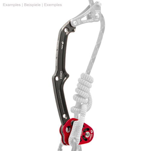 Squirrel Tether, climbing device with black metal arm and red aluminum block to which a gray rope with knots is attached, parts of the rope and other equipment are hidden.