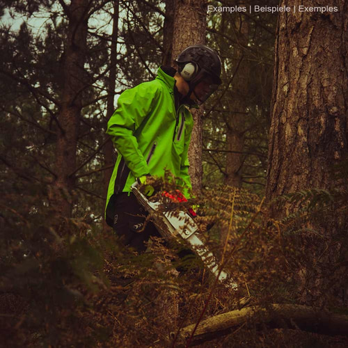 Person wearing green BreatheDry smock jacket with black pants and helmet in the forest, holding a chainsaw