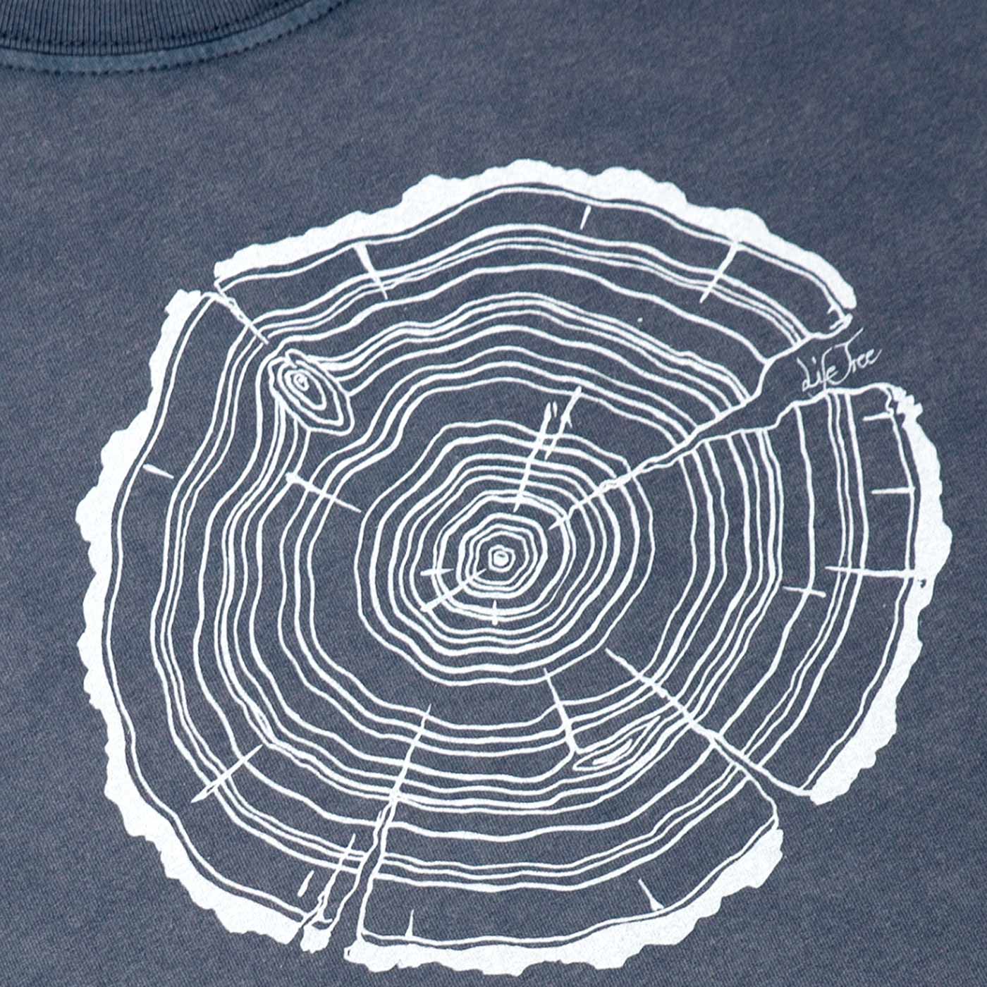 Close-up of white tree trunk cut print on a dark blue t-shirt, product name Treeslice