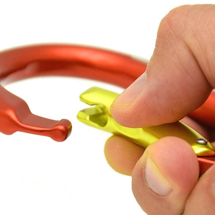 Hand holding yellow clasp of a red snap hook, product name paddle is visible
