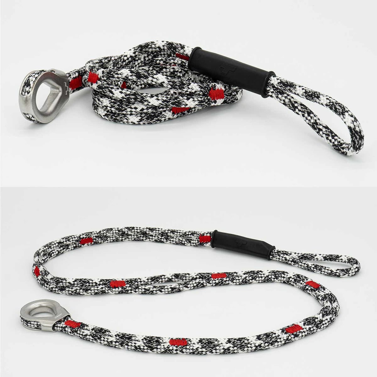 canopyANCHOR Thimble made of black, white and red rope with metal eyelet and loop, lying on a white background