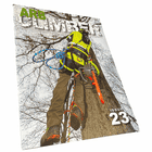 Arb Climber No. 23 magazine with a climber in yellow protective clothing on a tree trunk, chainsaw on the side, title in large letters at the top and issue number 23 at the bottom right, photographed at a slight angle