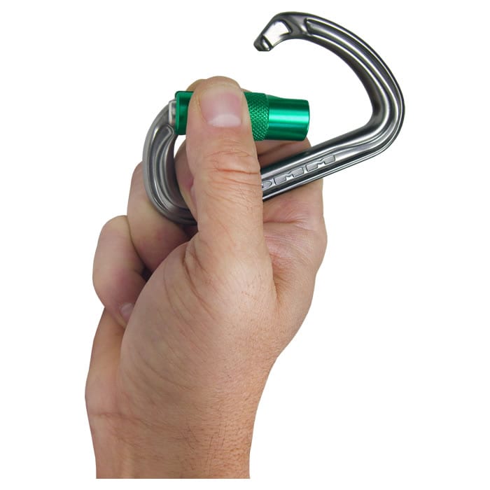 Shadow carabiner with green screw cap, manufacturer DMM, type not visible held in one hand against white background