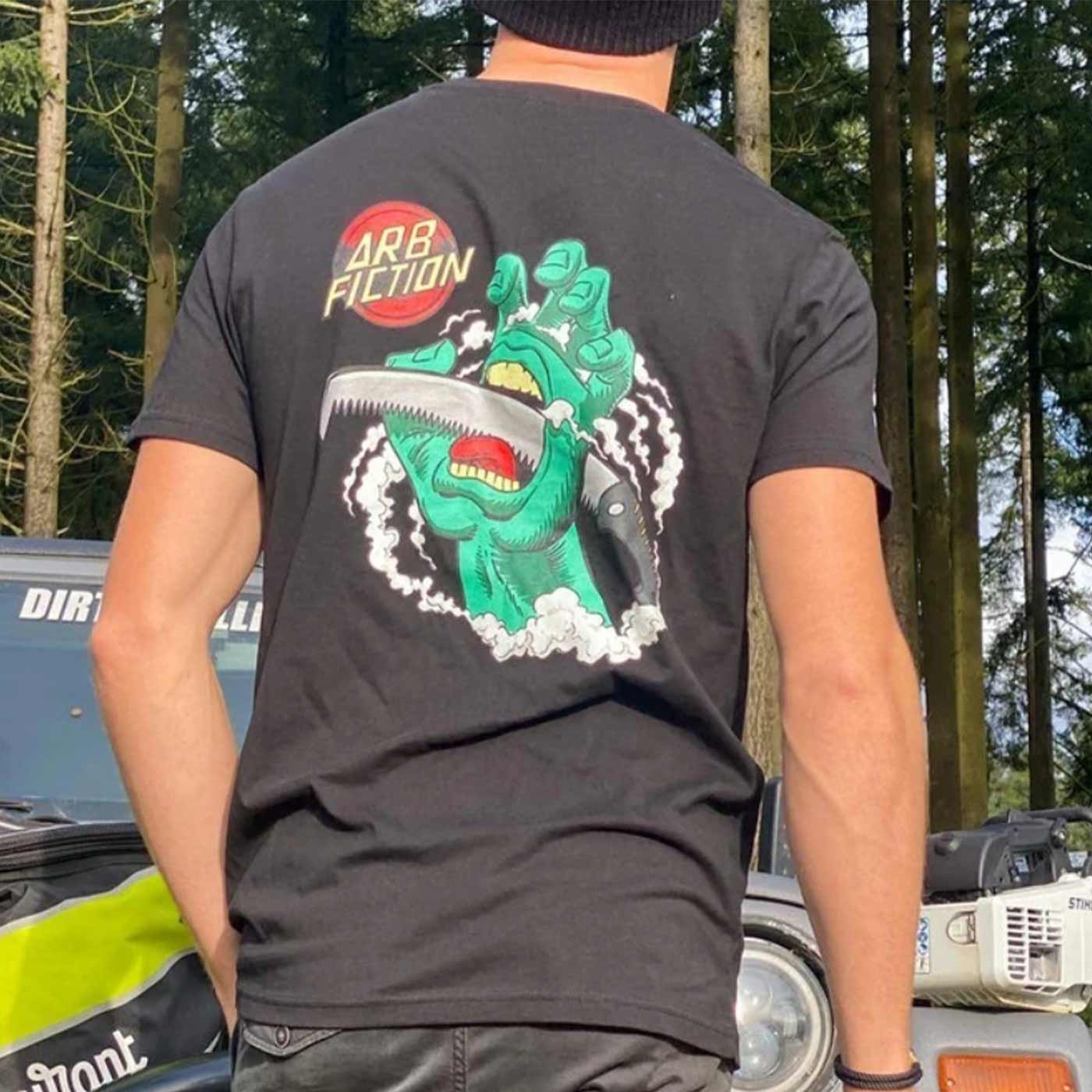 Person wearing the black T-shirt with a large print of the green hand and the "ARB FICTION" logo on the back, product name Screaming Hand