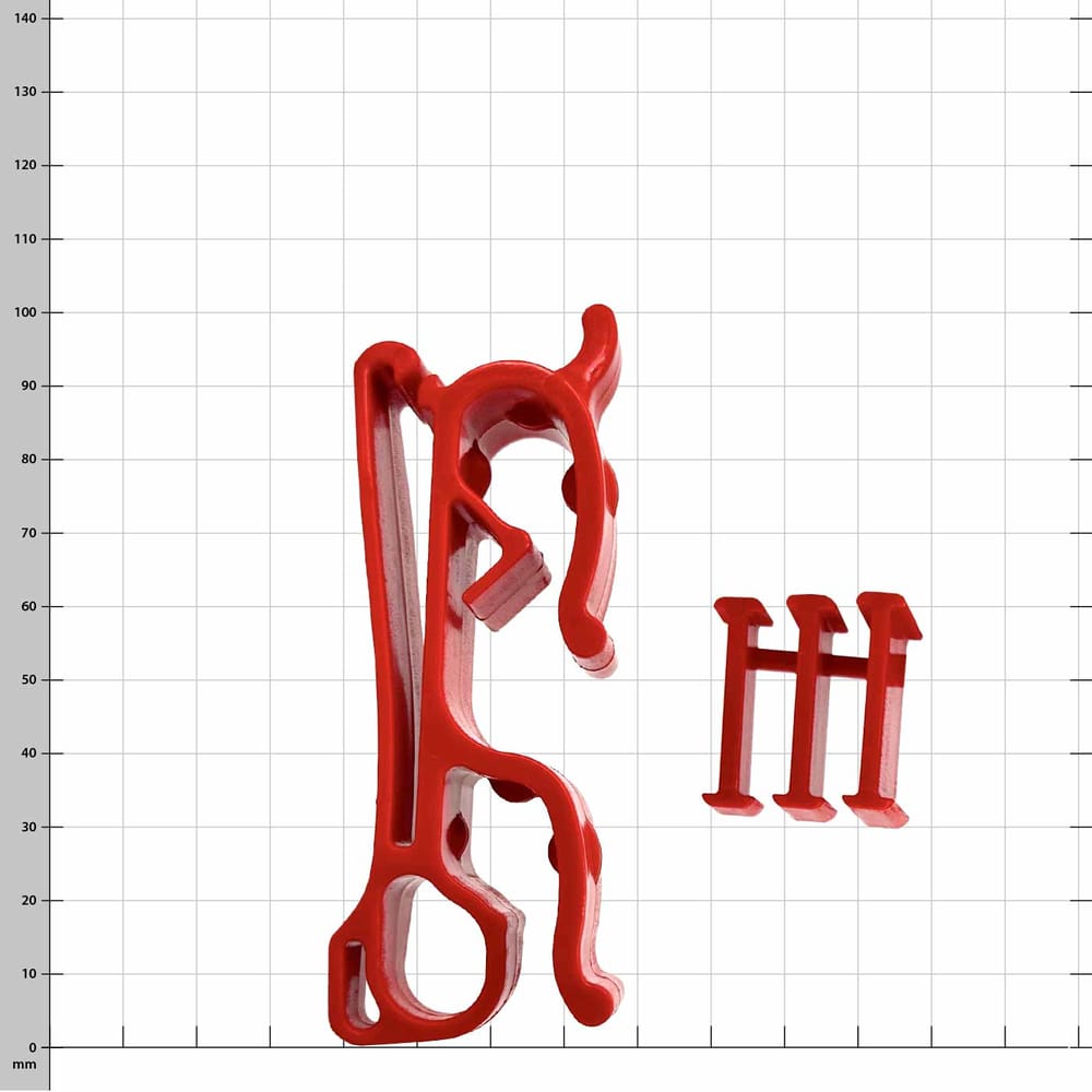 Buddy red plastic clip with three small red plastic pieces on white checkered background