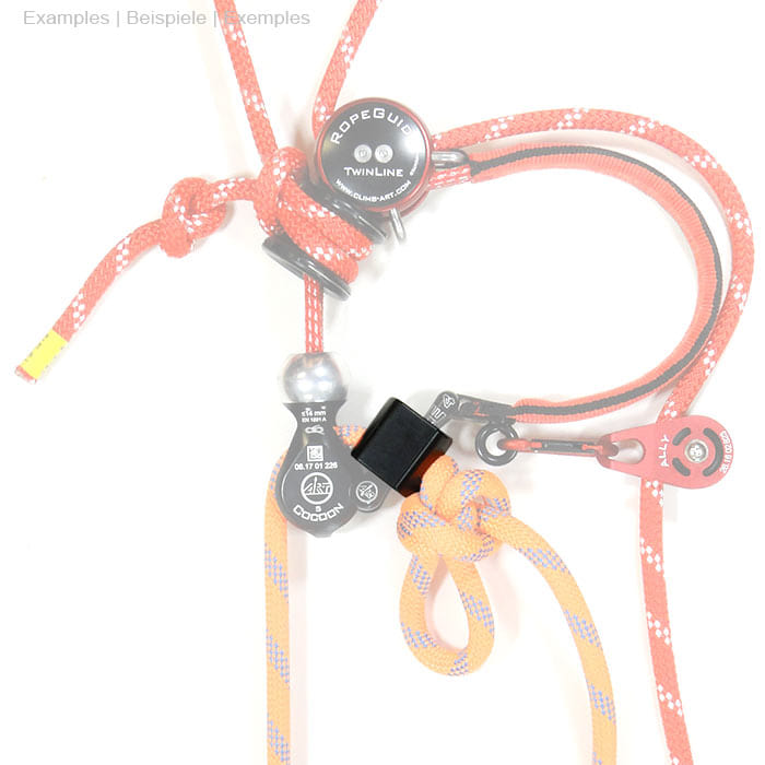 StopperGate black plastic part on red and orange ropes with knots and metal parts, background white