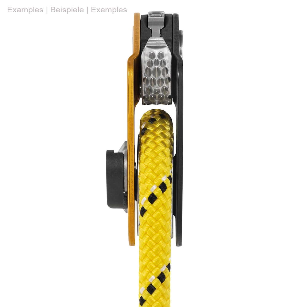Side view of the Petzl Mini Traxion pulley in yellow and black with yellow rope between the pulleys