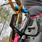 Close-up of a blue swinger snap hook attached to a black belt with multiple carabiners